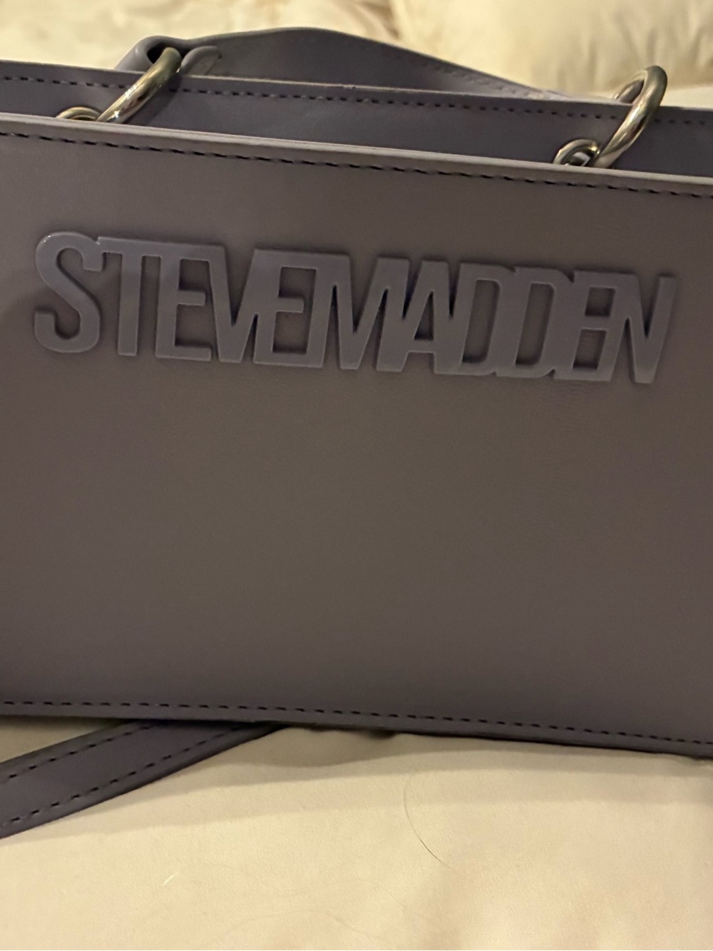 Steve Madden Lavender Messenger Bag with Embossed Logo, two straps, and card bag